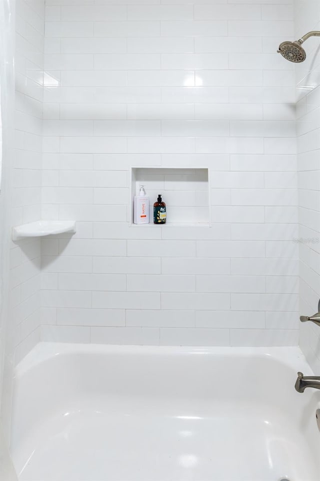 bathroom with bathing tub / shower combination
