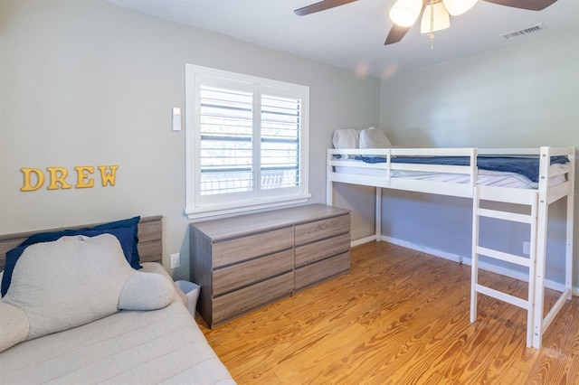 bedroom featuring visible vents, light wood-style floors, and ceiling fan