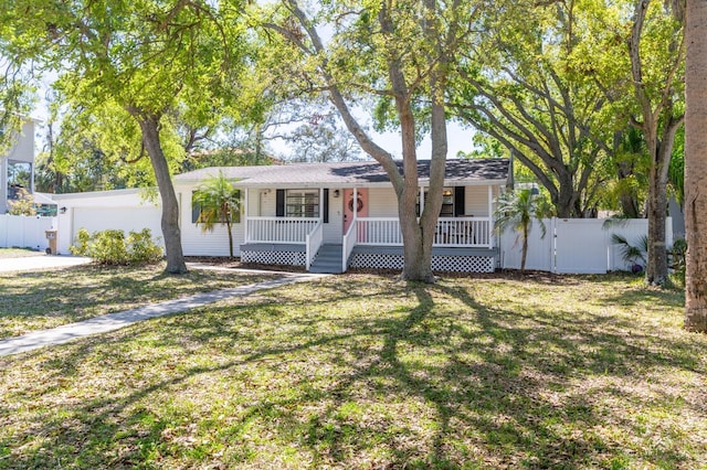 single story home featuring a front lawn, a garage, fence, and covered porch