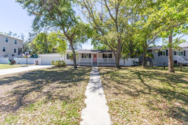 single story home with fence, a porch, concrete driveway, a front yard, and an attached garage