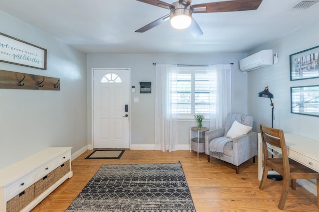 foyer entrance featuring visible vents, light wood-style flooring, a wall mounted AC, and ceiling fan