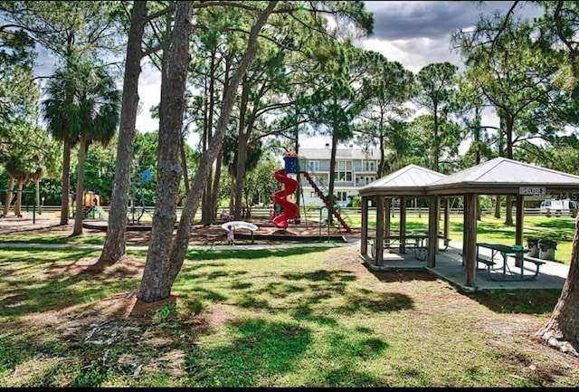 view of community with a gazebo, playground community, and a yard
