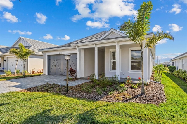 view of front of property with a garage and a front lawn