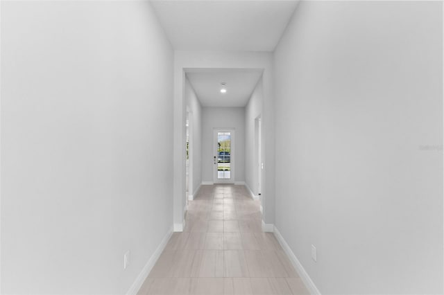 hall featuring light tile patterned floors