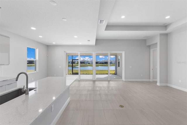 kitchen with sink and light stone countertops