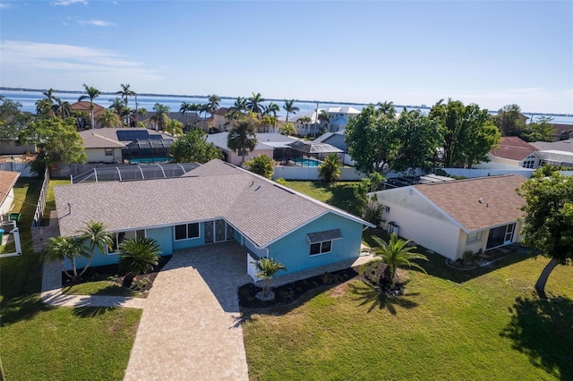 birds eye view of property featuring a water view and a residential view