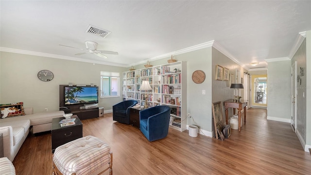 living room featuring wood finished floors, visible vents, and baseboards