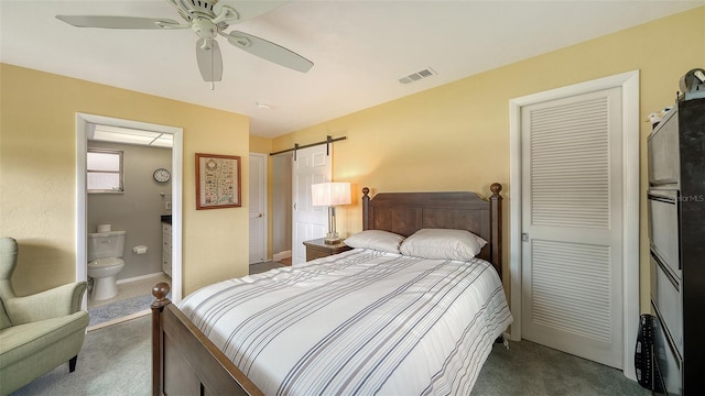 bedroom with dark colored carpet, a barn door, visible vents, and a ceiling fan