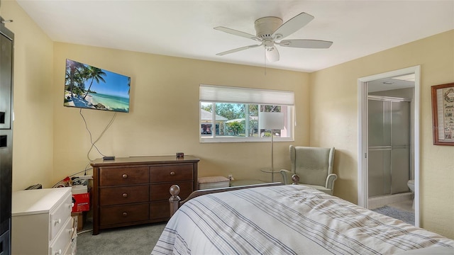 bedroom with a ceiling fan, light colored carpet, and ensuite bath