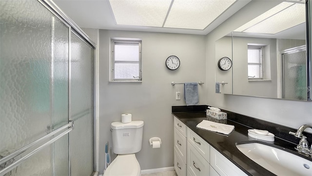 full bath with a stall shower, plenty of natural light, and vanity