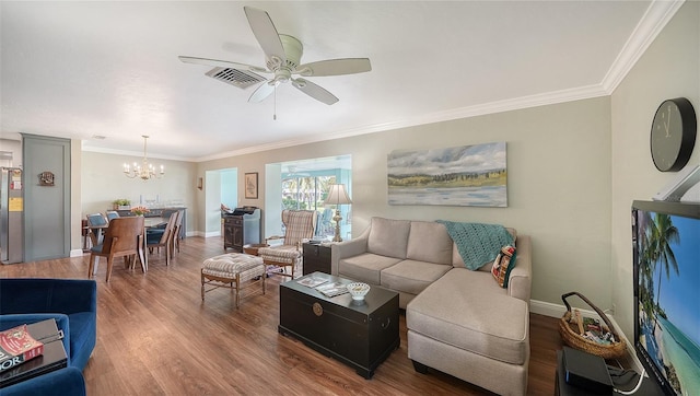 living room featuring crown molding, baseboards, wood finished floors, and ceiling fan with notable chandelier