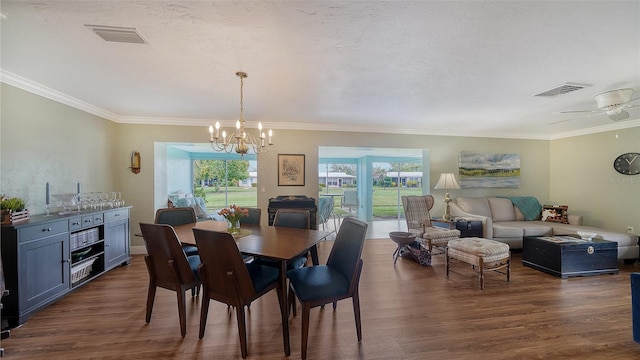 dining area featuring visible vents, dark wood-type flooring, and ornamental molding