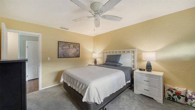 bedroom with baseboards, visible vents, ceiling fan, and light colored carpet