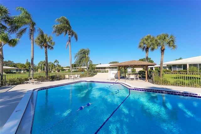 pool with a gazebo, a patio area, and fence