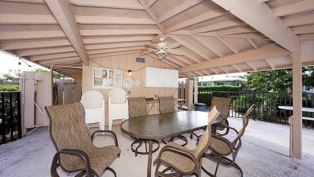 view of patio / terrace featuring a ceiling fan, outdoor dining area, and fence