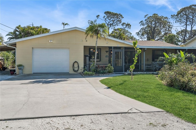 single story home featuring a garage, a sunroom, and a front lawn