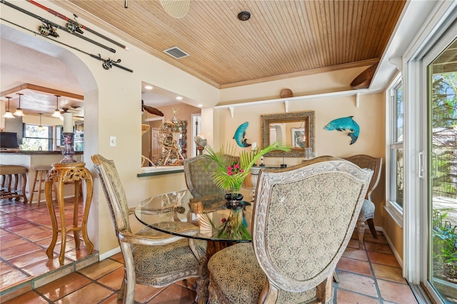 dining area featuring wood ceiling and ornamental molding