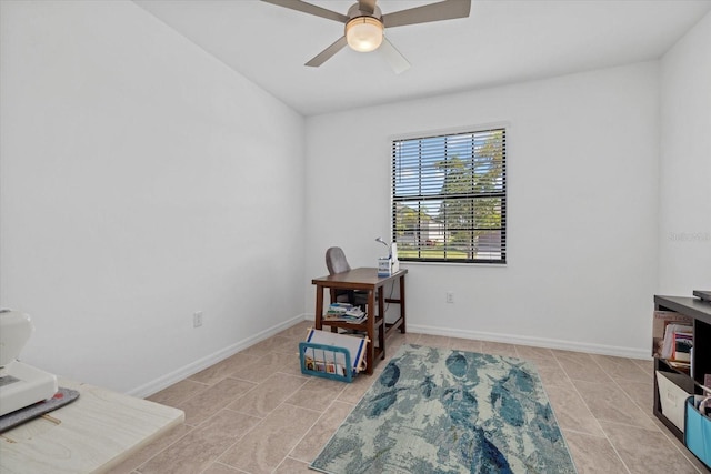 interior space with light tile patterned flooring, ceiling fan, and baseboards