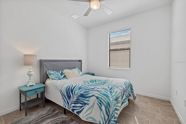 bedroom with ceiling fan and baseboards