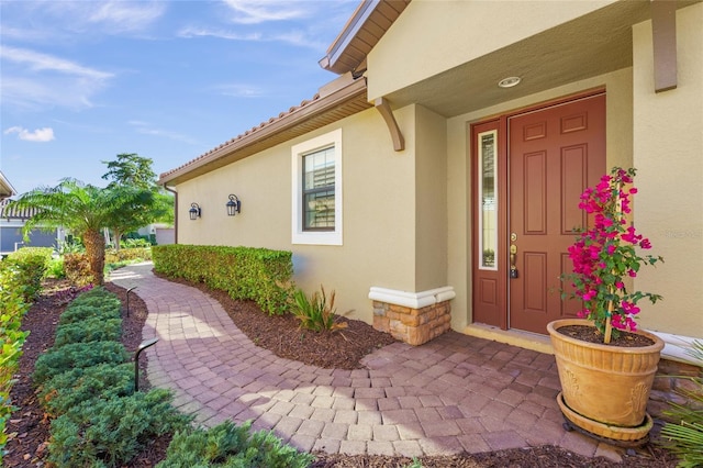 property entrance with stucco siding