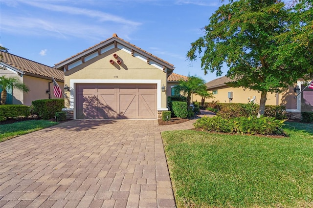 5556 Cantucci St, Nokomis, FL 34275 - mediterranean / spanish-style house with decorative driveway, an attached garage, stucco siding, a front lawn, and stone siding
