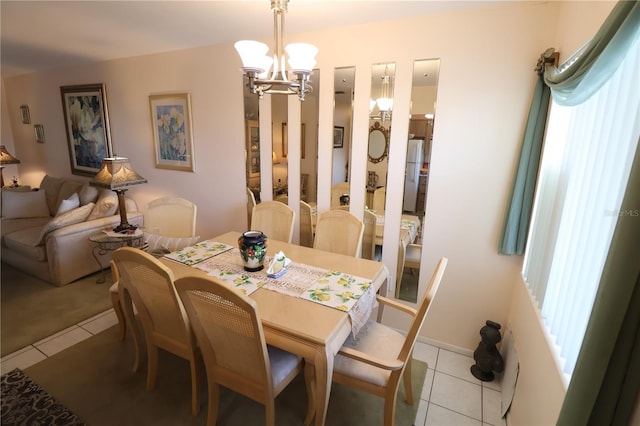 dining area with light tile patterned floors, a notable chandelier, and a healthy amount of sunlight