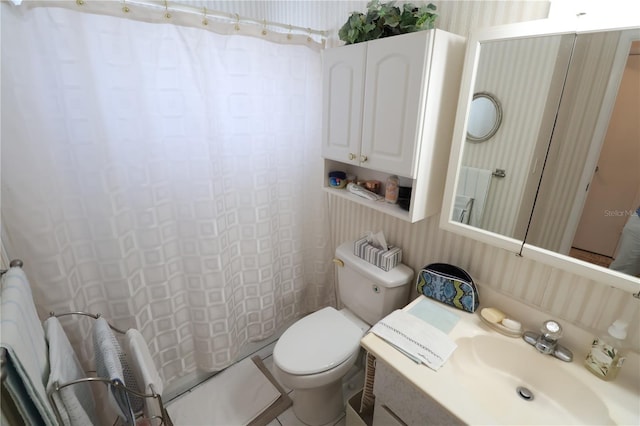 full bathroom featuring vanity, shower / bath combo with shower curtain, and toilet