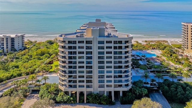 aerial view with a water view and a beach view