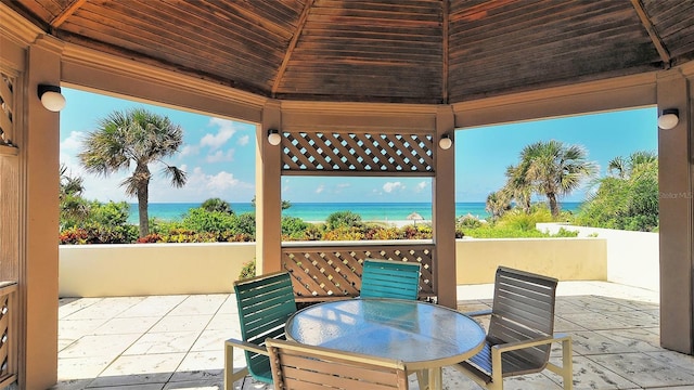 view of patio featuring a gazebo and a water view