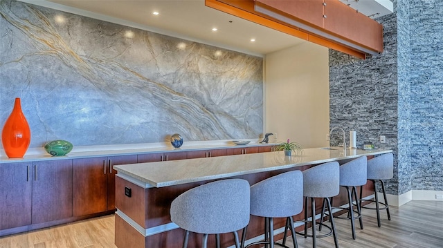 bar with light wood-type flooring