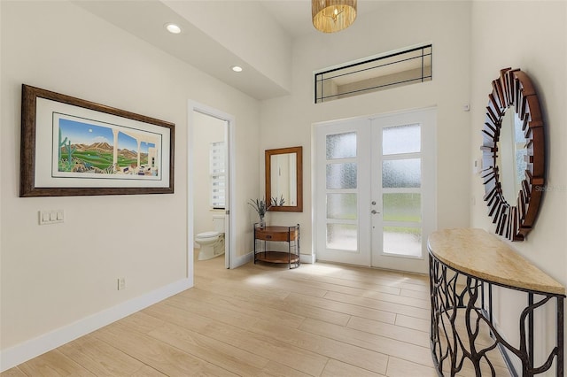 foyer entrance featuring french doors and light hardwood / wood-style flooring