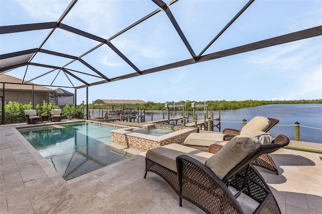 view of pool featuring a patio, a water view, glass enclosure, and an in ground hot tub