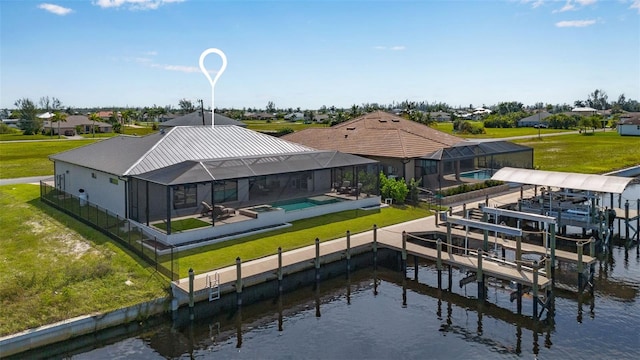 back of property featuring a patio area, a lawn, a water view, and glass enclosure