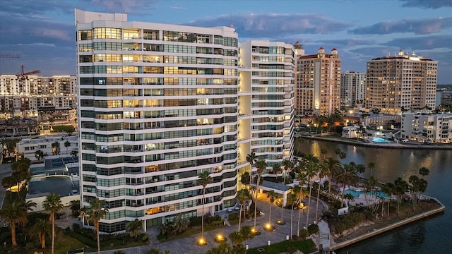 outdoor building at dusk featuring a water view