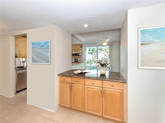 kitchen featuring stainless steel appliances, light tile patterned flooring, ceiling fan, and a textured ceiling