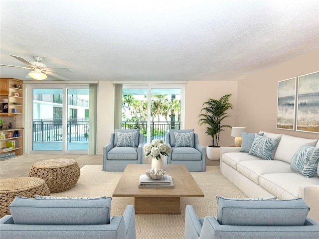 tiled living room with ceiling fan, a wealth of natural light, and a textured ceiling