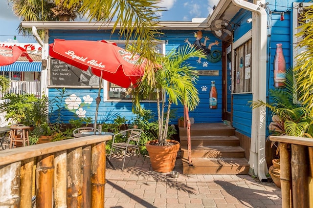 view of exterior entry featuring a patio area