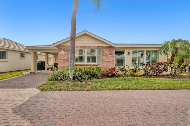 single story home with a carport and a front yard