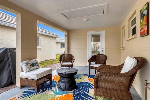 view of patio with an outdoor living space and a grill