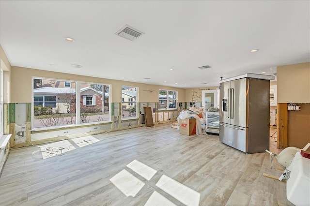 kitchen featuring high end refrigerator and light hardwood / wood-style floors