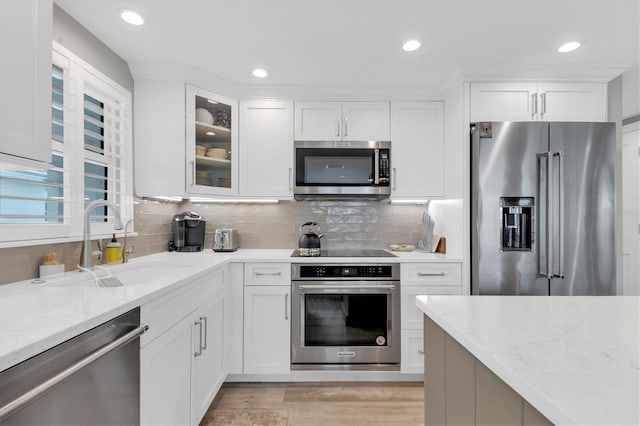 kitchen featuring white cabinetry, appliances with stainless steel finishes, and sink