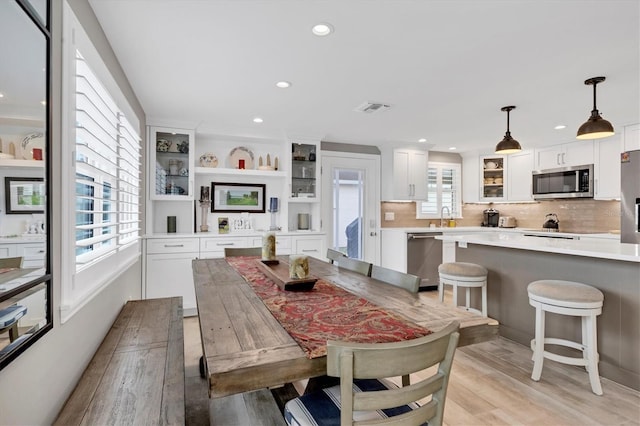 dining area featuring sink and light hardwood / wood-style flooring