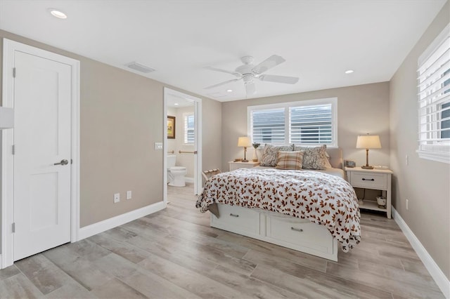 bedroom featuring ensuite bath, light hardwood / wood-style floors, and ceiling fan