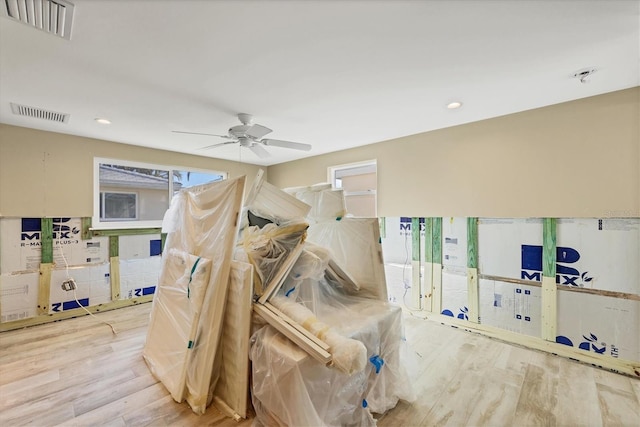 rec room with light hardwood / wood-style floors and ceiling fan