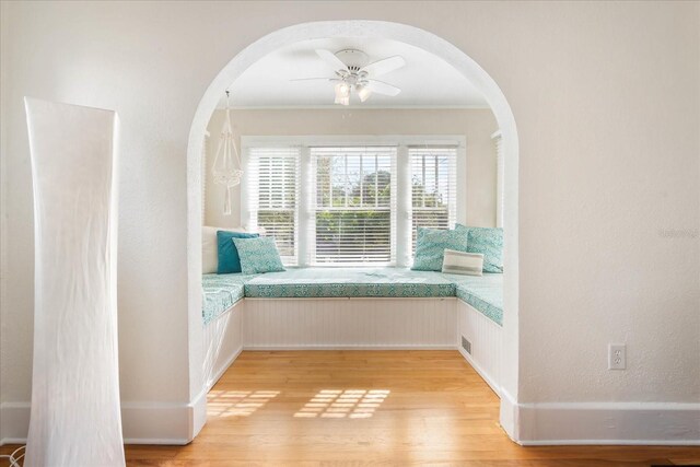 unfurnished room featuring ornamental molding, ceiling fan, and light hardwood / wood-style flooring