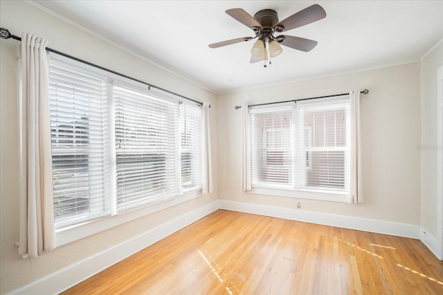 unfurnished room with hardwood / wood-style floors, crown molding, and ceiling fan