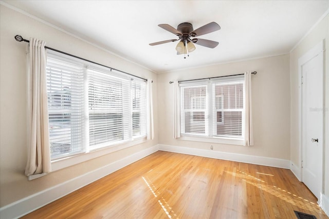 spare room with ornamental molding, hardwood / wood-style floors, and ceiling fan