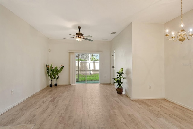 unfurnished room featuring light wood finished floors, baseboards, visible vents, and ceiling fan with notable chandelier