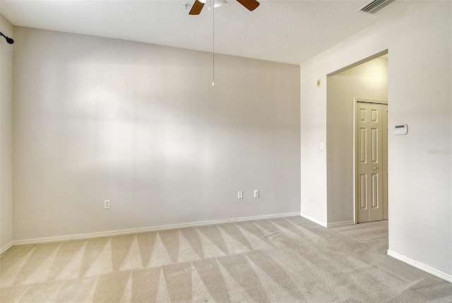 unfurnished room featuring ceiling fan, carpet, visible vents, and baseboards