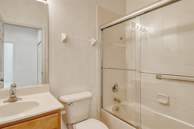 full bath featuring toilet, combined bath / shower with glass door, and vanity